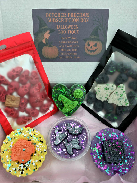 October Precious Subscription Box featuring Halloween-themed fragrances with bottles and festive decorations.