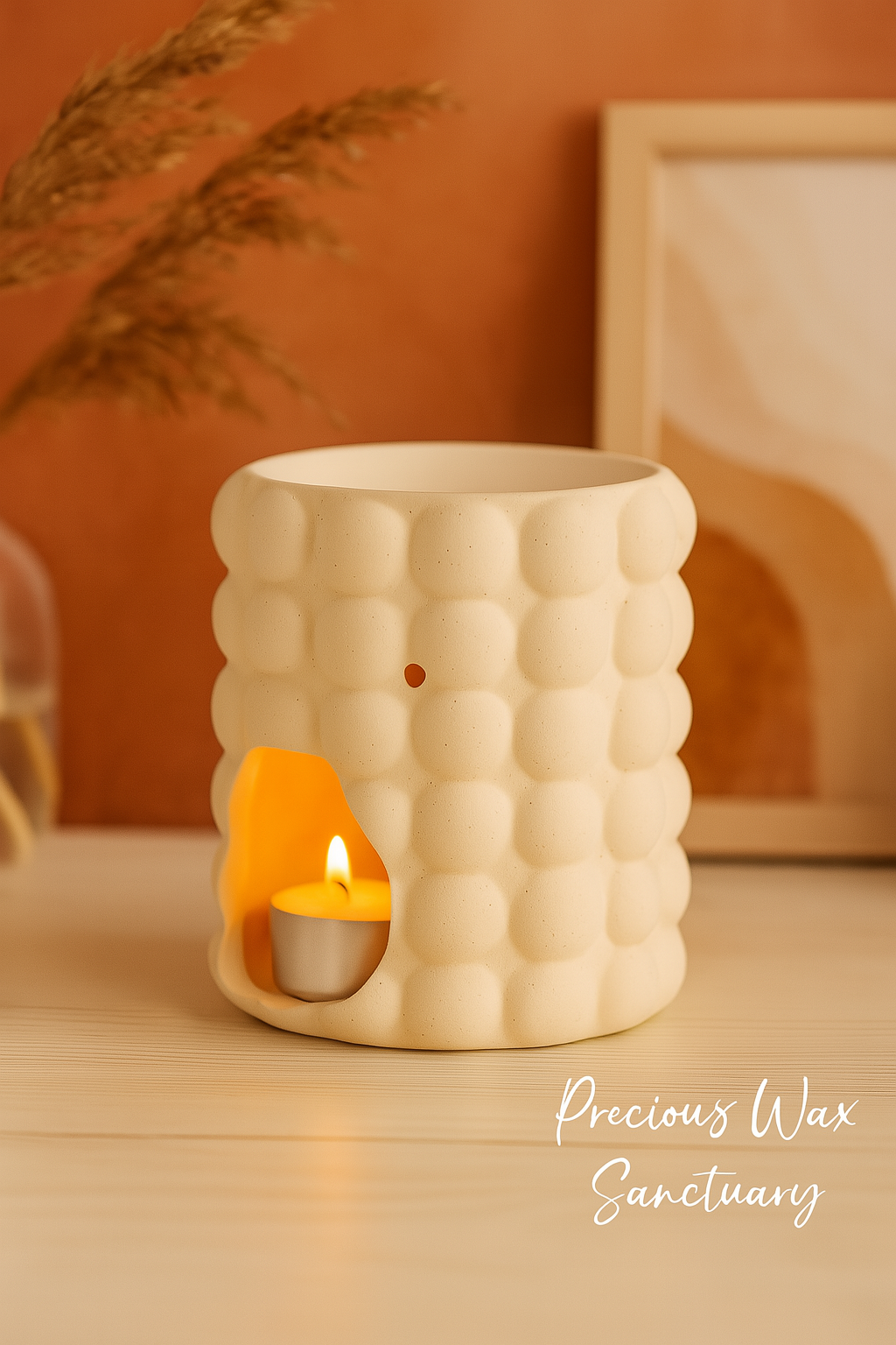 White textured wax warmer with a small candle inside on a wooden surface.