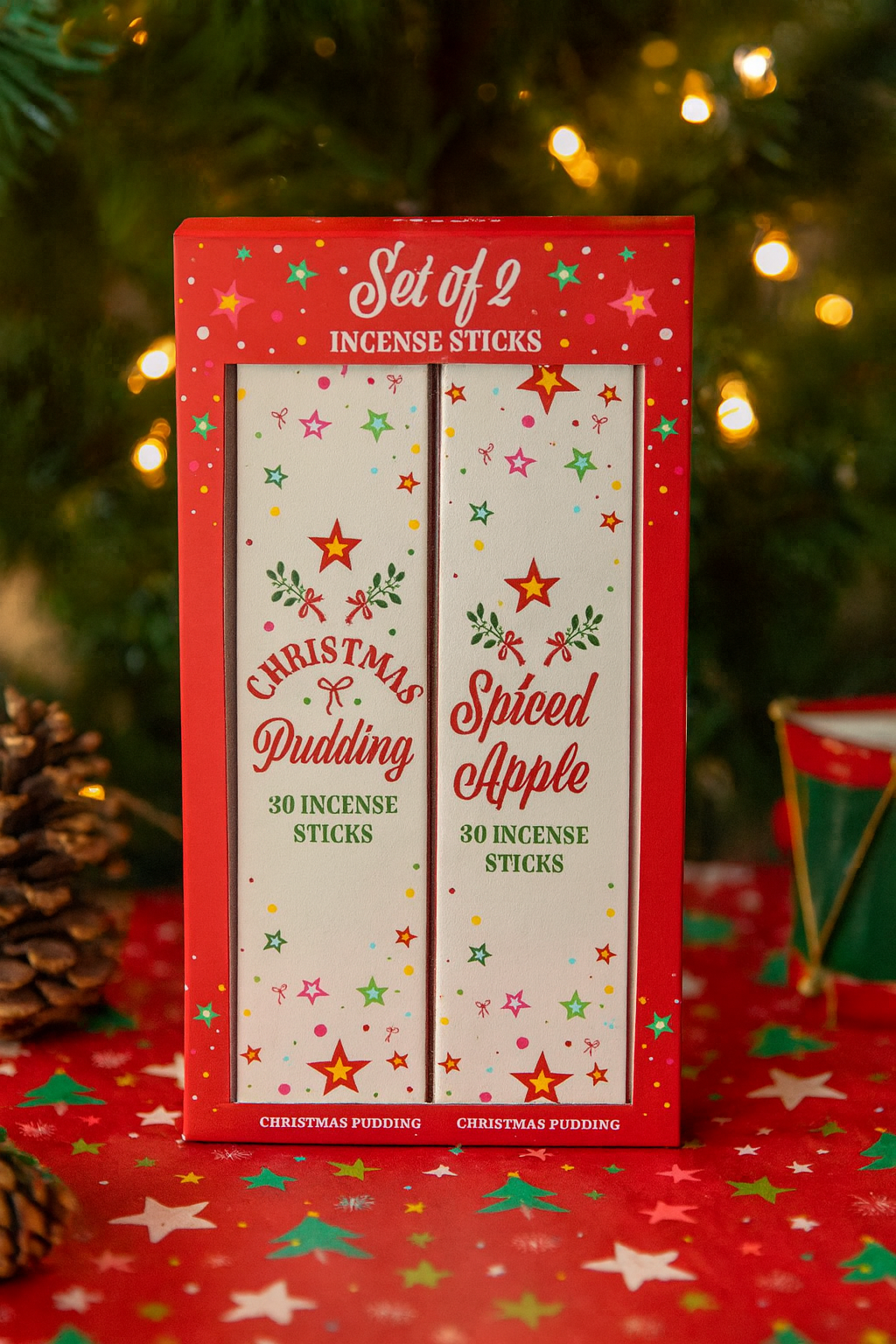 Set of 2 incense sticks packaging with Christmas pudding and spice apple scents against a festive background.