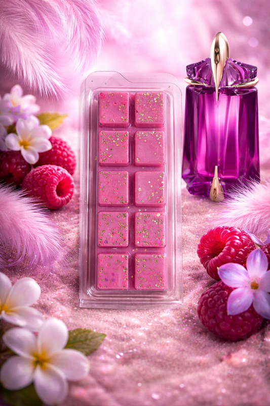 Pink wax melts in a mold with a purple perfume bottle on a pink background with flowers and berries.