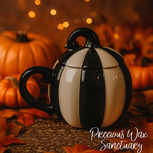 Black and white striped pumpkin-shaped mug with pumpkins and leaves in the background