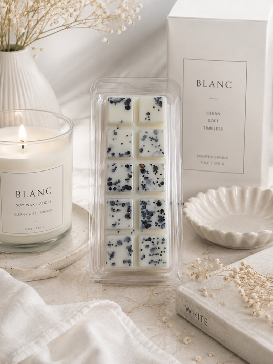 Blanc candle and wax melts packaging on a neutral background