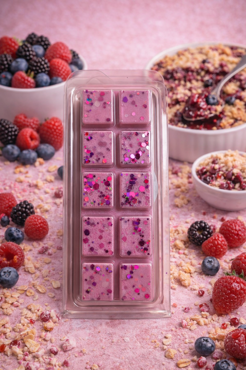 Pink wax melt bar surrounded by berries and cereal on a pink background