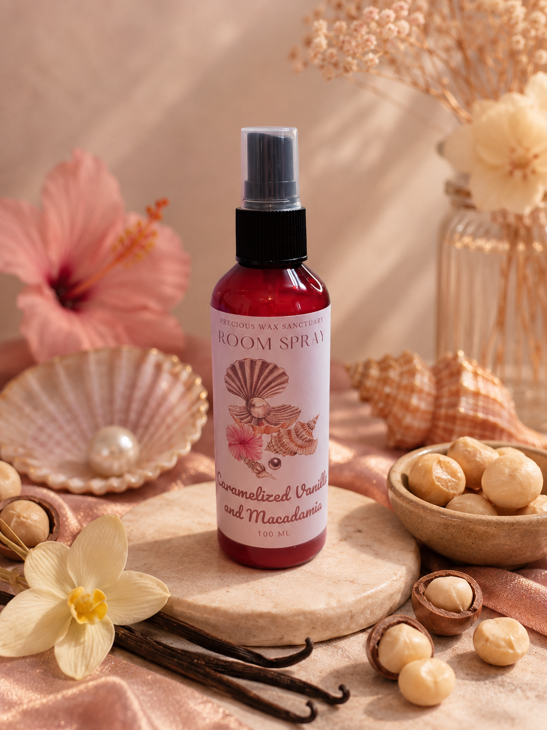 Room spray bottle with floral design on a decorative setting with flowers and shells.
