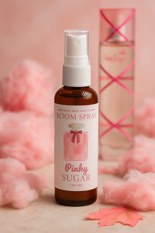 A bottle of Pinky Sugar room spray with a vibrant design, featuring a sweet citrus scent with notes of lemon, bergamot, lily of the valley, musk, candyfloss, and vanilla pods.