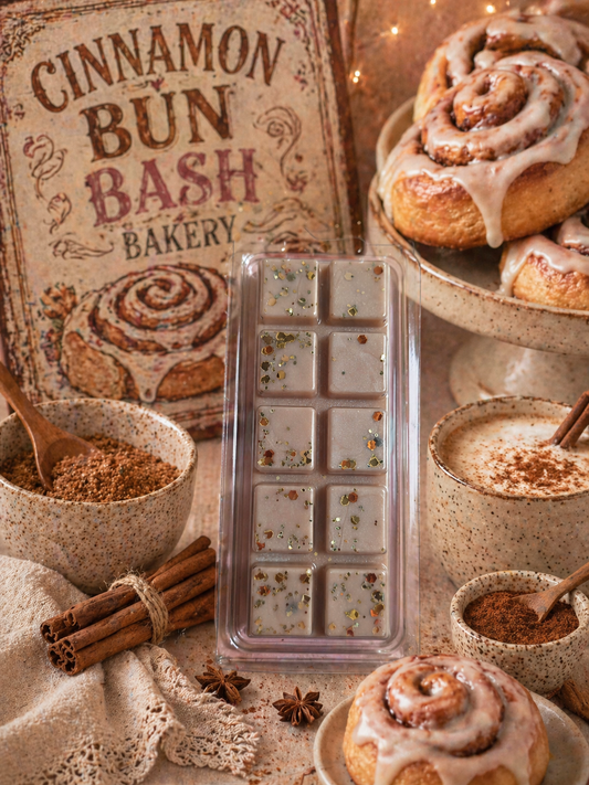 Cinnamon bun-themed bakery setup with a wax melt and cinnamon buns.