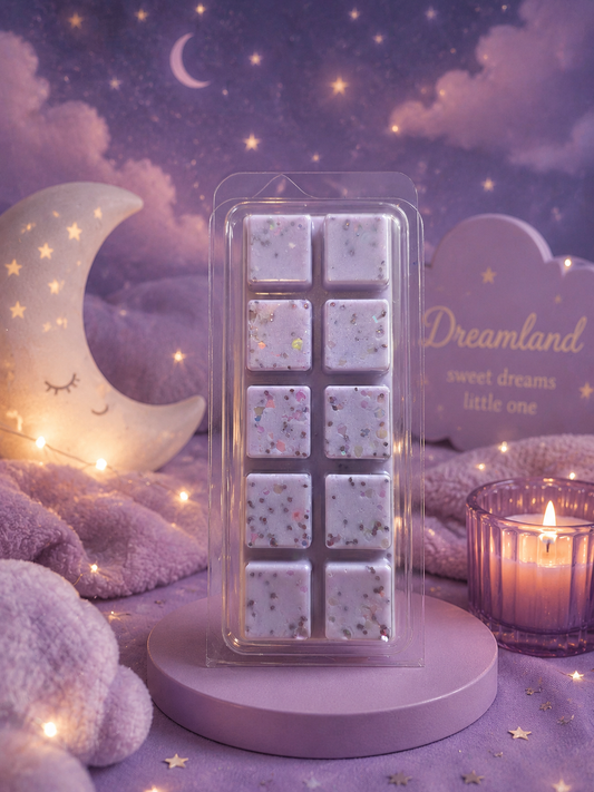 A packaged set of wax melts with multicolor glitter flecks, displayed on a round lavender stand against a cozy, dreamy purple night sky background with a crescent moon lamp, star lights, and a candle.
