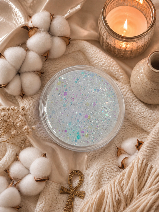 Egyptian cotton and cashmere must gel wax melt pot surrounded by cotton and cosy decor.