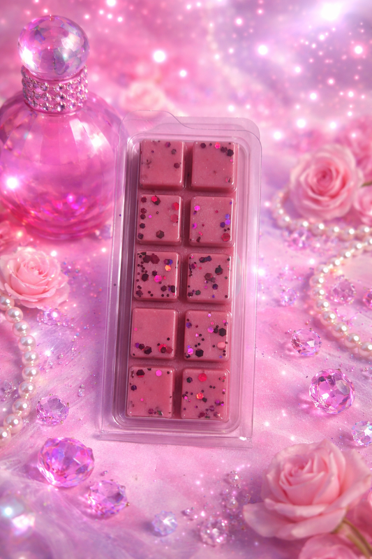 Pink wax melt with pink roses and decorative elements on a glittery background