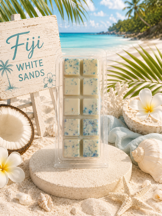 Pack of Fiji White Sands wax melts on a beach setting with palm leaves and ocean view.