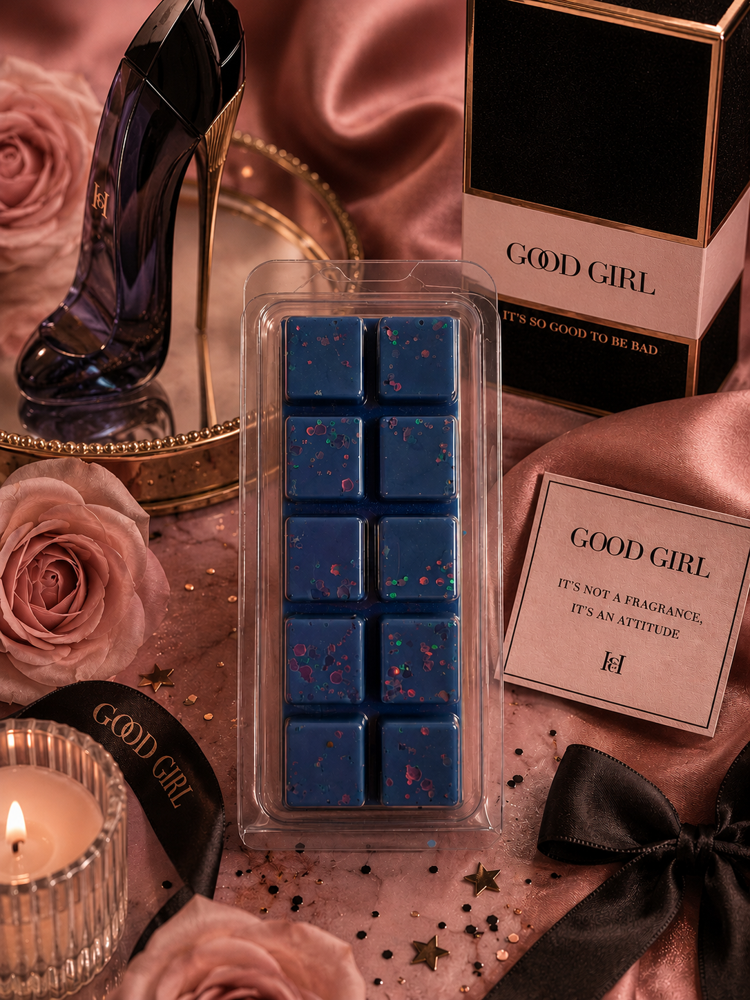Blue wax melts in a clear packaging with 'Good Girl' branding, surrounded by roses and a candle.