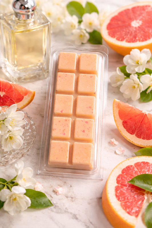 Grapefruit wax melt bar surrounded by grapefruits.