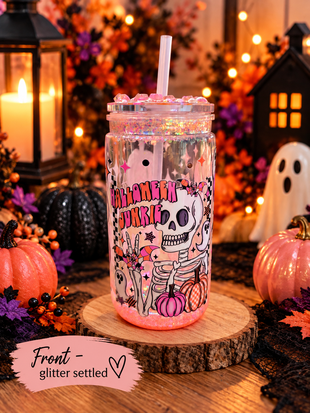 16oz halloween theme glitter tumbler shown from front glitter settled with spooky halloween decor.