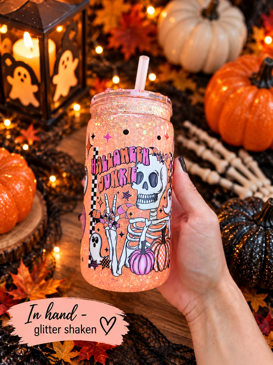 16oz snowglobe halloween tumbler in hand with glitter shaken and spooky halloween home decor.