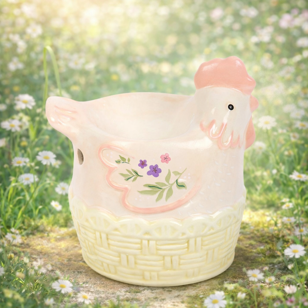 Ceramic wax and oil chicken-shaped melter burner with floral design in a garden setting