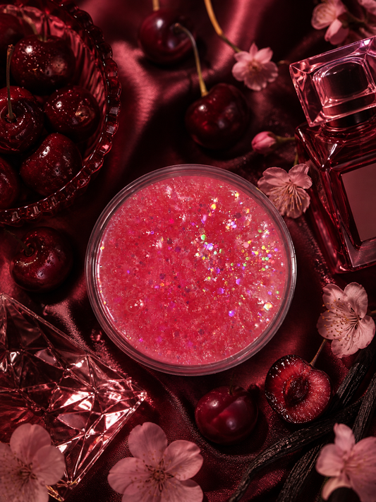 Lost cherry gel wax melt pot surrounded by cherries and blossom.