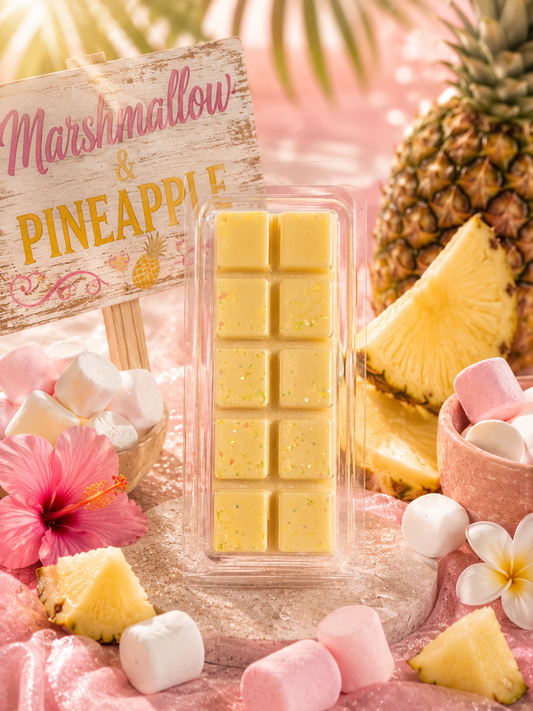 Marshmallow and pineapple wax melt with a pineapple and marshmallows on a pink background.