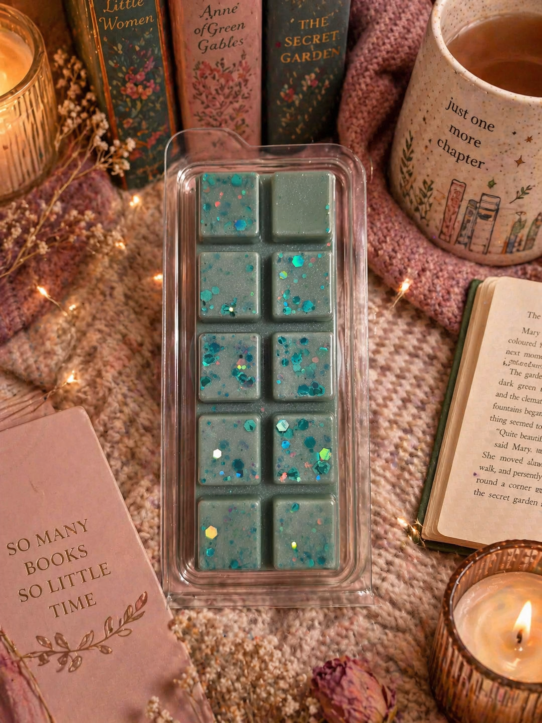 Teal wax melts in a clear container with books and candles in the background