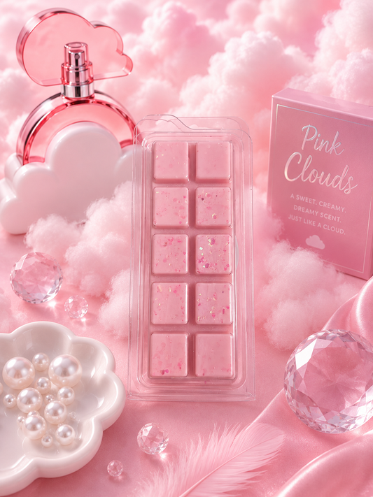 Pink Clouds scented wax melts in a clear rectangular tray, styled with a pink perfume bottle, cloud-shaped props, pearls, faceted crystals, and a pink product box on a soft pink background.