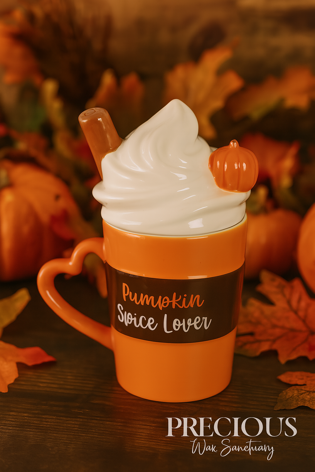 Orange mug with whipped cream and pumpkins, labeled 'Pumpkin Spice Lover', on a wooden surface with autumn leaves.