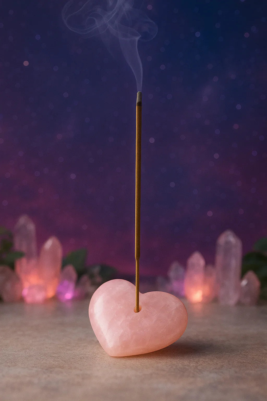 Incense stick on a heart-shaped rose quartz stone with crystals in the background
