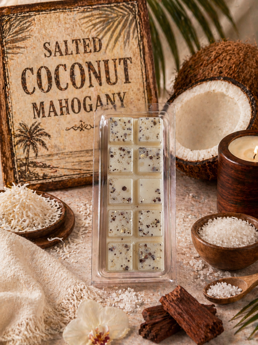 Salted Coconut Mahogany wax melts with coconuts, salt, and chocolate on a rustic background.