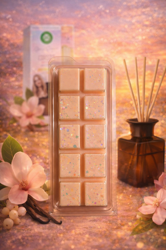 Rectangular wax melt container with decorative elements on a soft, blurred background