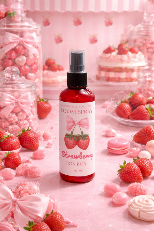 Strawberry-themed 'Room Spray' bottle surrounded by strawberries and pink candies on a pink background.