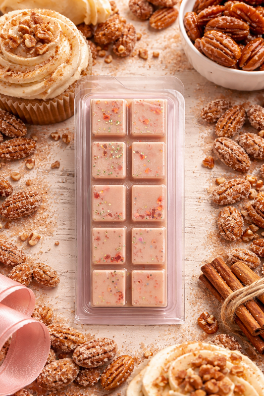 Packaged wax melt bar with pecans and cinnamon sticks on a rustic surface