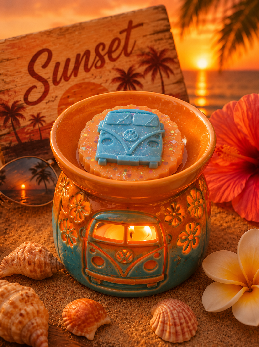 Sunset scented wax melt in burner on beach with shells.