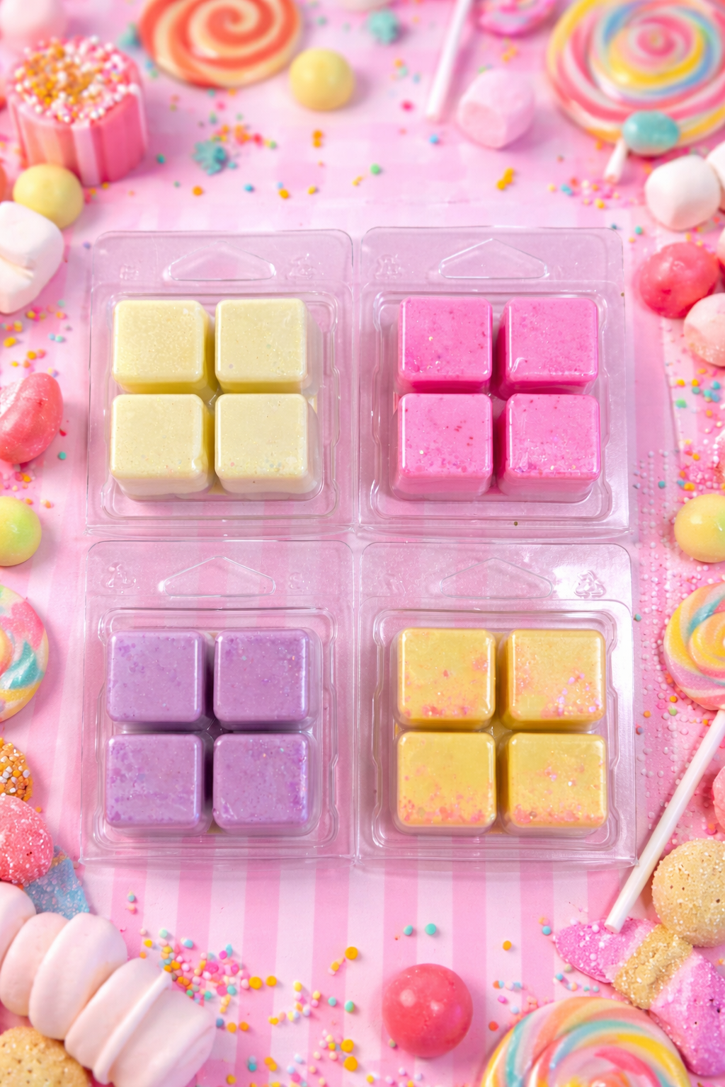 Colourful wax melts on a pink background with candies around