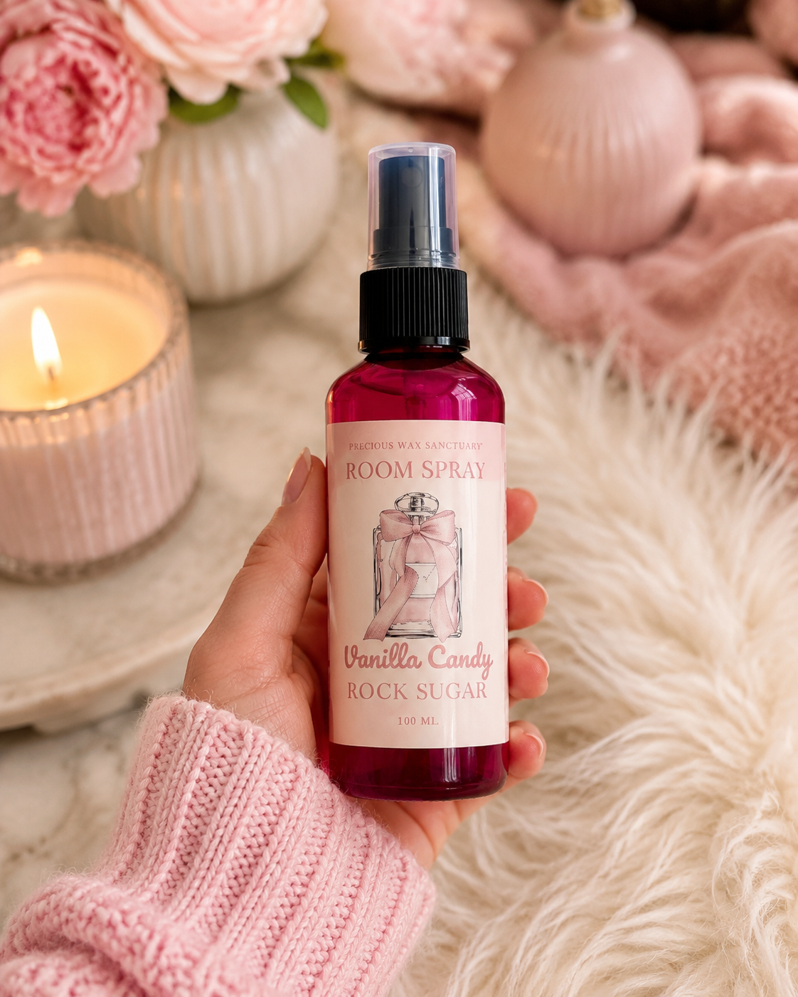 Room spray in the scent vanilla candy rock sugar in hand at home.